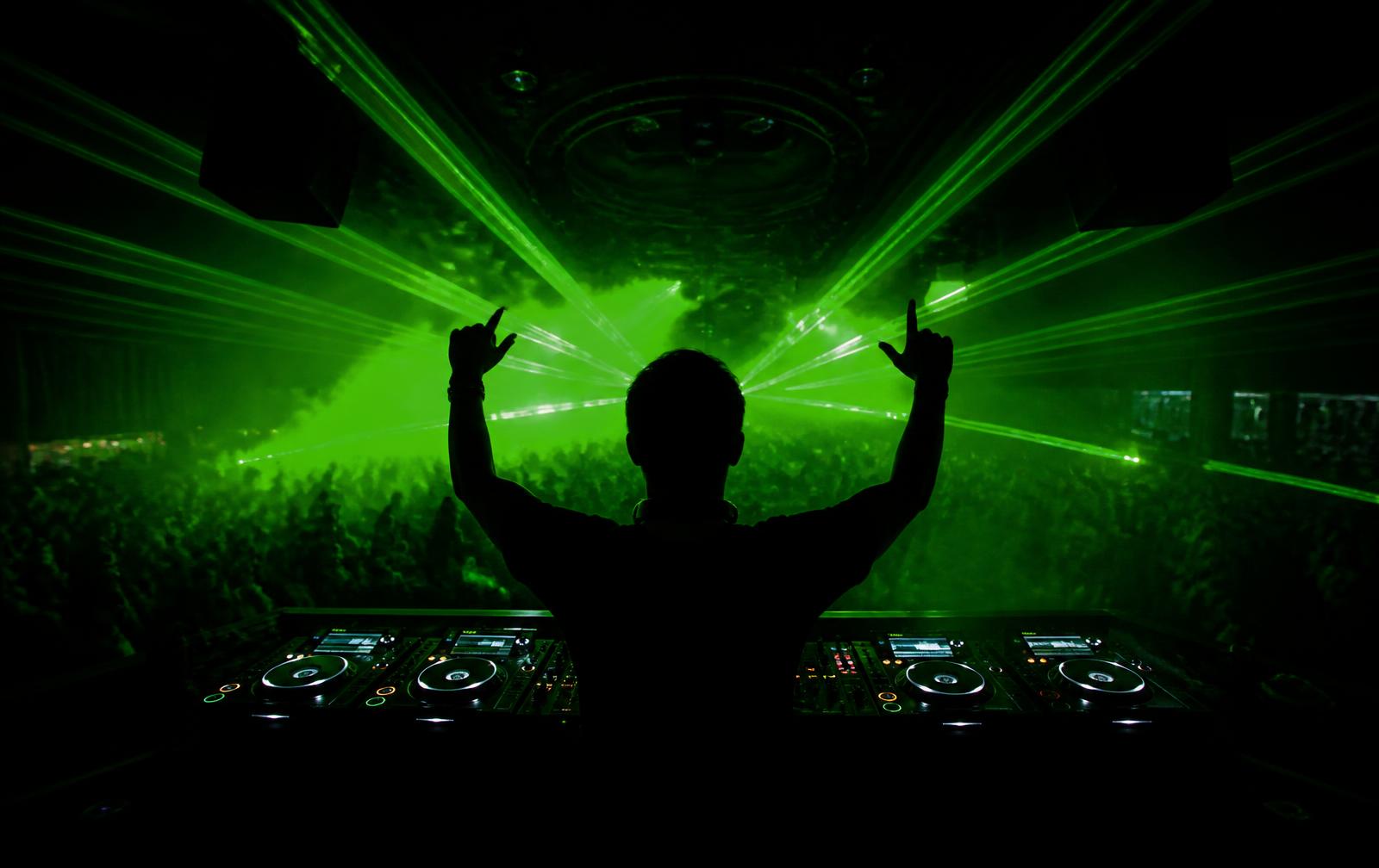 Nano The DJ performing behind the decks under green lasers — website built by LABX Digital Studio